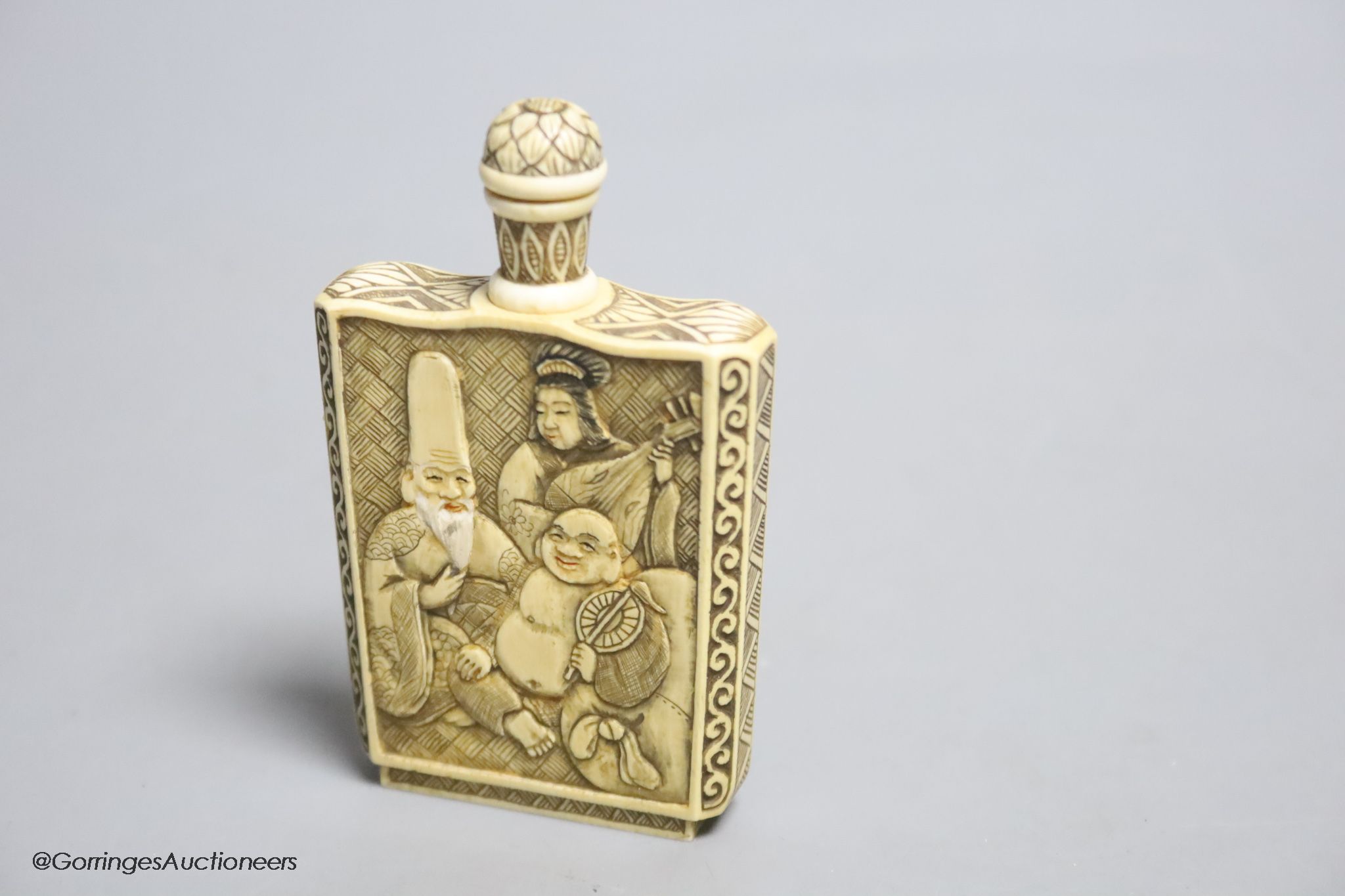 A Japanese carved ivory ‘Gods of Happiness’ snuff bottle, early 20th century